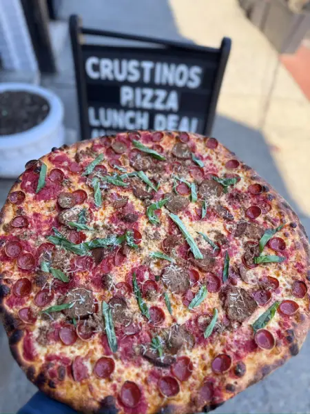 Freshly baked Crustinos Pizza specialty pie with sausage and peppers.