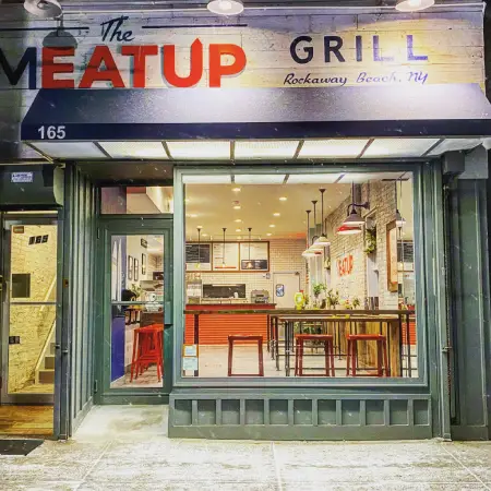 The Meat Up Grill storefront with a bright and welcoming entrance showcasing the modern dining space inside.