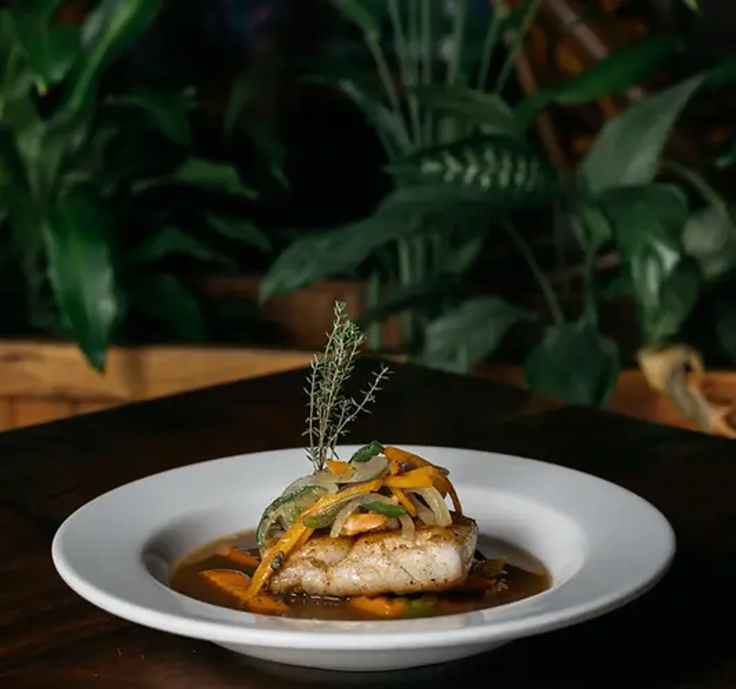 Grilled Caribbean snapper with local vegetables, served at Rockhouse Restaurant in Negril, Jamaica, showcasing fresh seafood cuisine at Rockhouse Hotel.