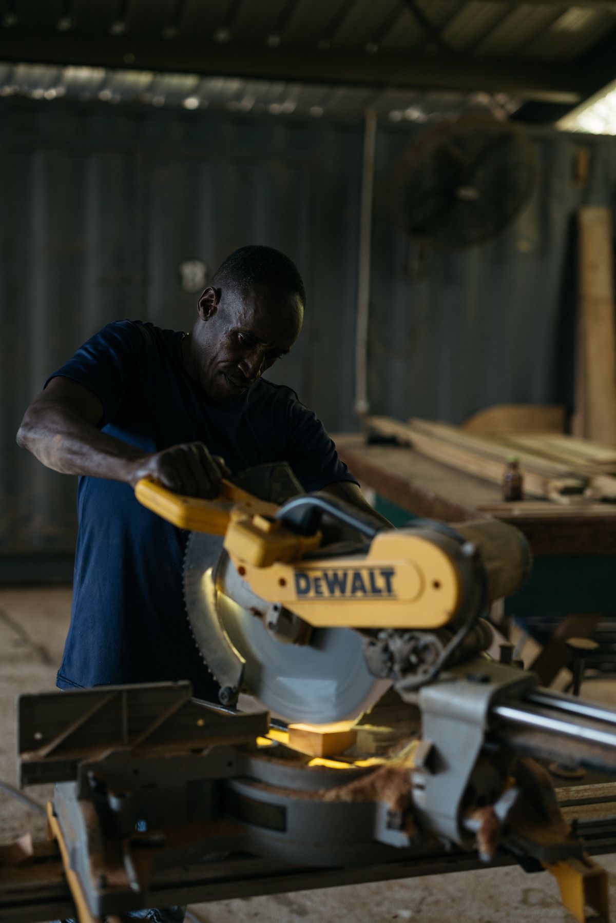 image of a man operating a wood saw at the Rockhouse woodwork shop at the Rockhouse hotel in Negril