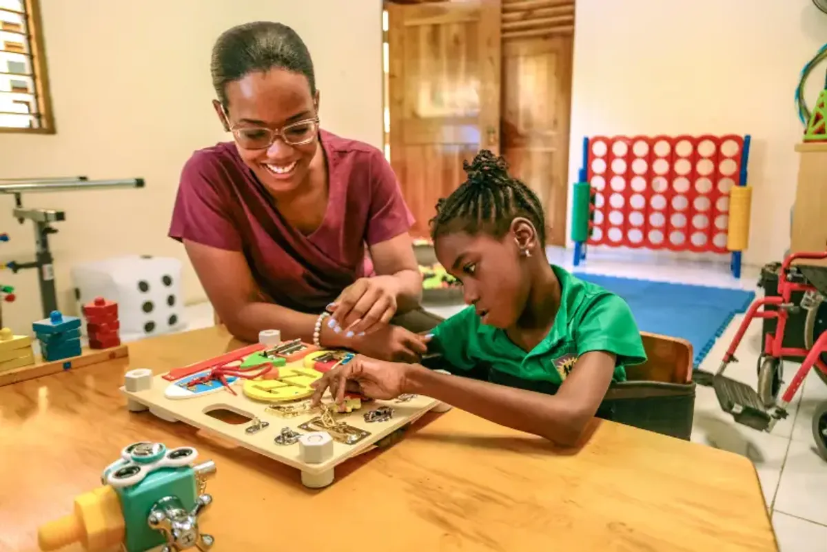 Aerial view of the Rockhouse Foundation school in Negril, Jamaica, showcasing the campus with its colorful buildings, green fields, and surrounding trees—a complete view of the school grounds.