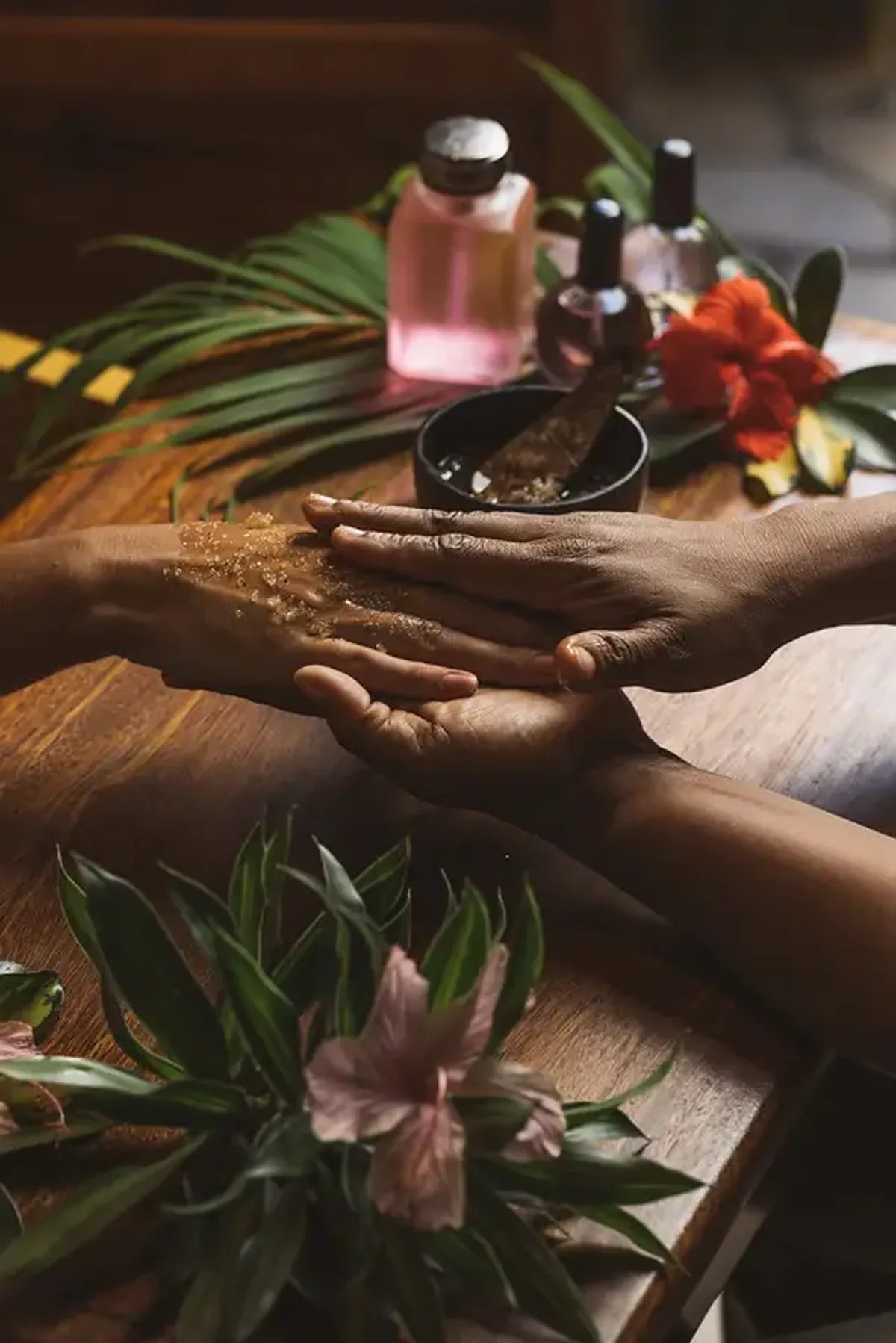 Hands receiving a scrub treatment at a spa in Rockhouse Hotel in Negril, Jamaica, highlighting a restorative spa experience at Rockhouse Hotel.
