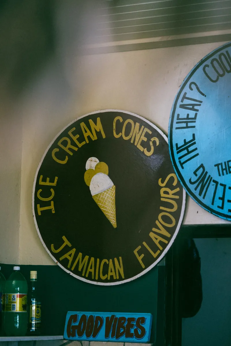 View of the hand painted ice cream cone sign hanging over the pool bar at the Rockhouse Hotel in Negril Jamaica