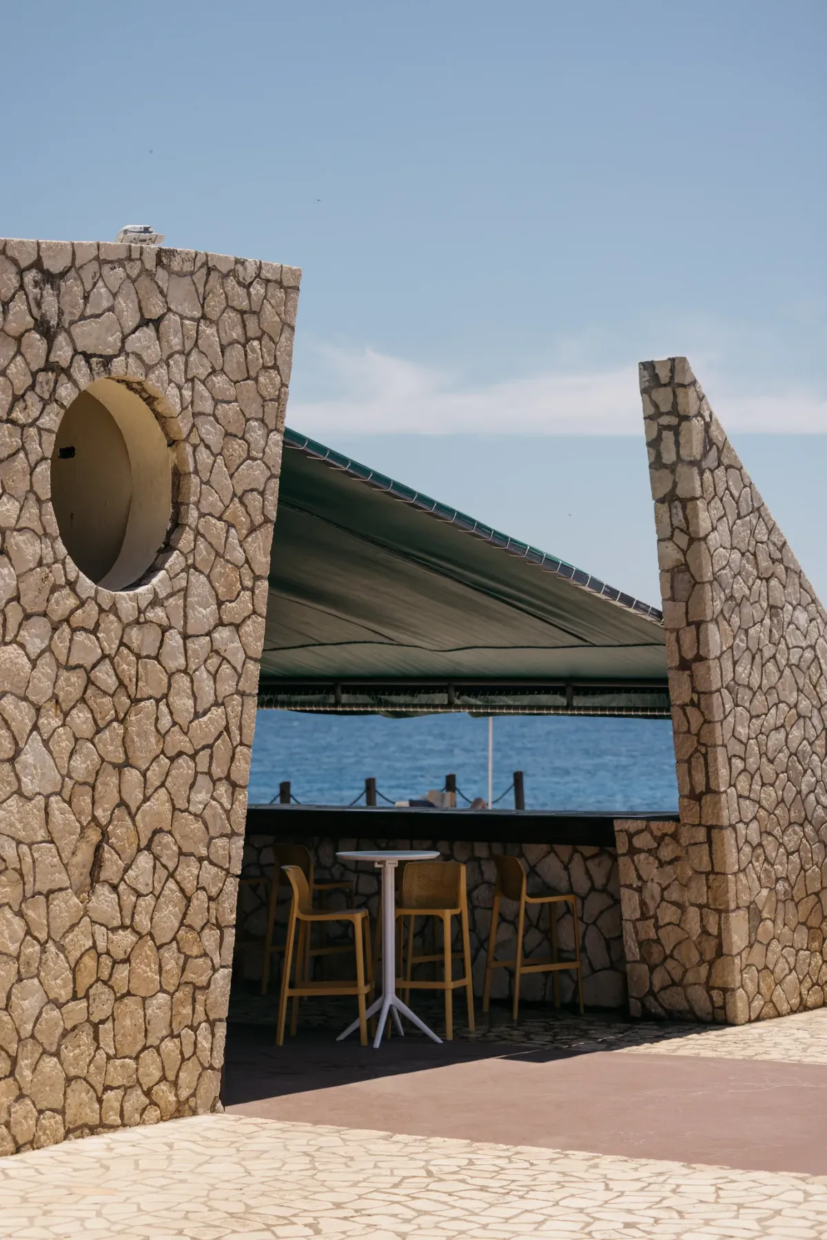 The Pool Bar and Grill overlooking the Caribbean Sea at Rockhouse Hotel in Negril, Jamaica, showcasing a relaxing poolside setting at Rockhouse Hotel.