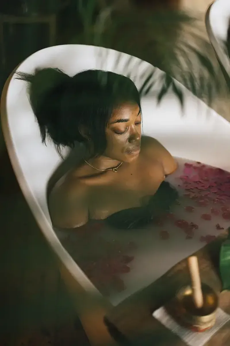 Woman relaxing in a flower petal bath at Rockhouse Hotel in Negril, Jamaica, highlighting a restorative spa experience at Rockhouse Hotel.