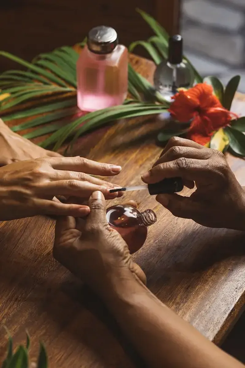 Close-up of a person receiving a manicure with nail polish at a spa in Rockhouse Hotel in Negril, Jamaica, highlighting a detail of the spa and beauty treatments at Rockhouse Hotel.