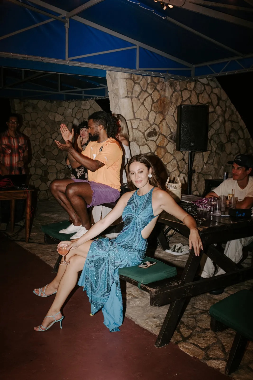 Image of a bride sitting on a bench at the Rockhouse Pool Bar at a wedding reception at Rockhouse Hotel in Negril, Jamaica, highlighting a romantic wedding venue at Rockhouse Hotel.