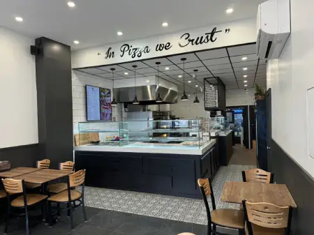 Crustinos Pizza storefront, showcasing their dedication to authentic New York-style pizza.