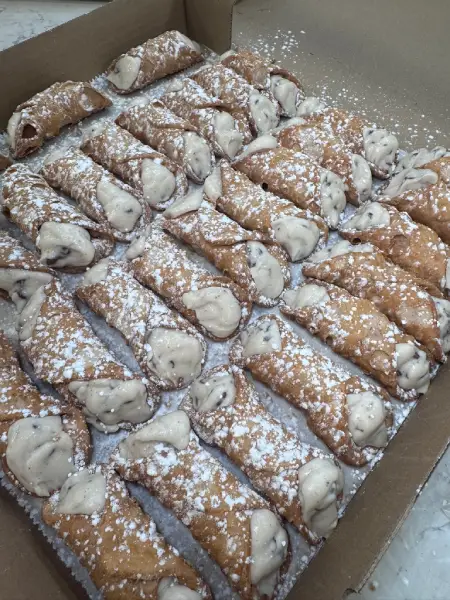 Powdered sugar pastries from Crustinos Pizza, baked to golden perfection.
