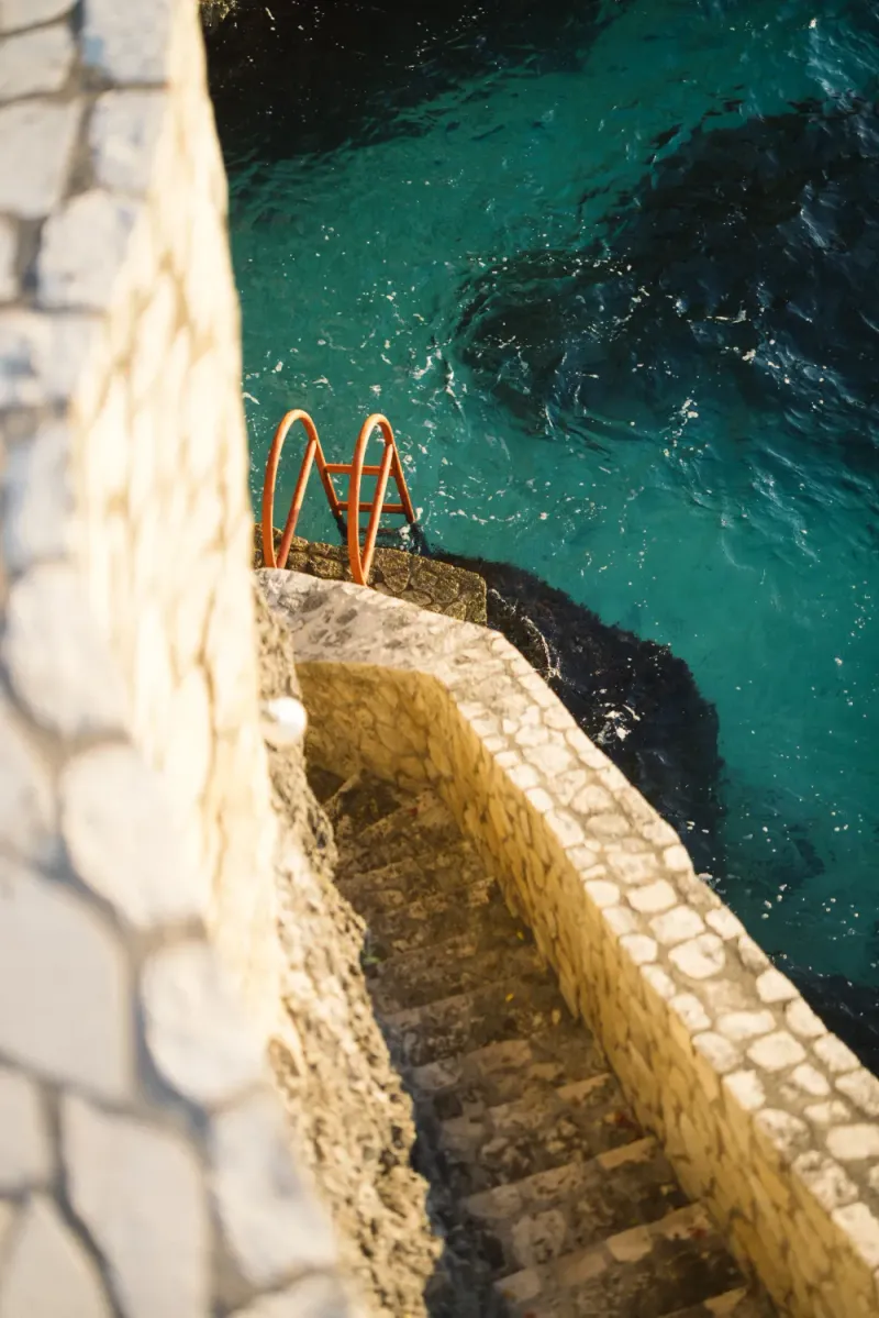 "Infinity pool overlooking the Caribbean Sea at Rockhouse Hotel in Negril, Jamaica, offering guests a serene oceanfront swimming experience