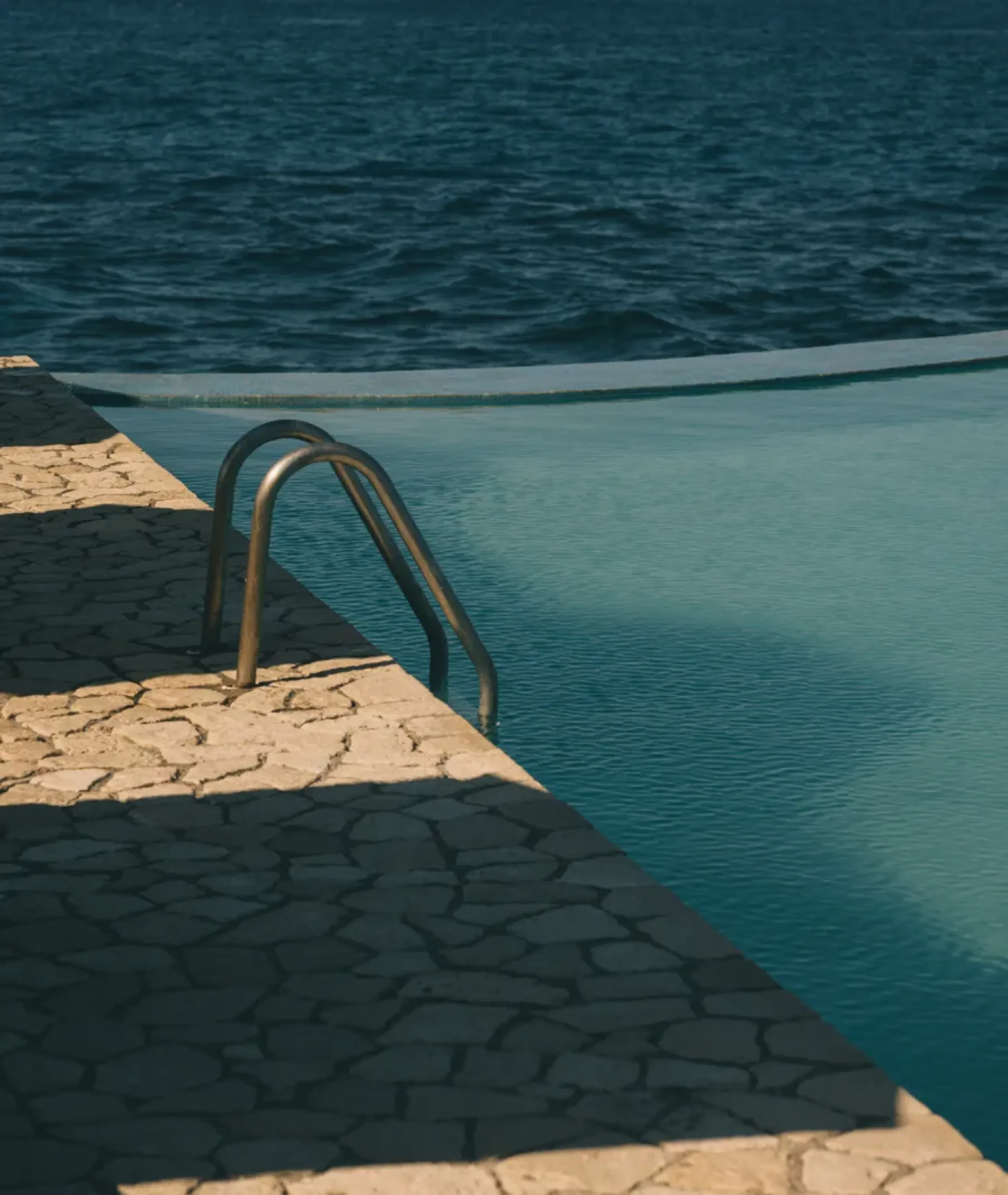 Romantic spa bath with tropical leaves, seashells, and vibrant flower petals at Rockhouse Hotel in Negril, Jamaica, offering a signature Caribbean wellness experience for couples