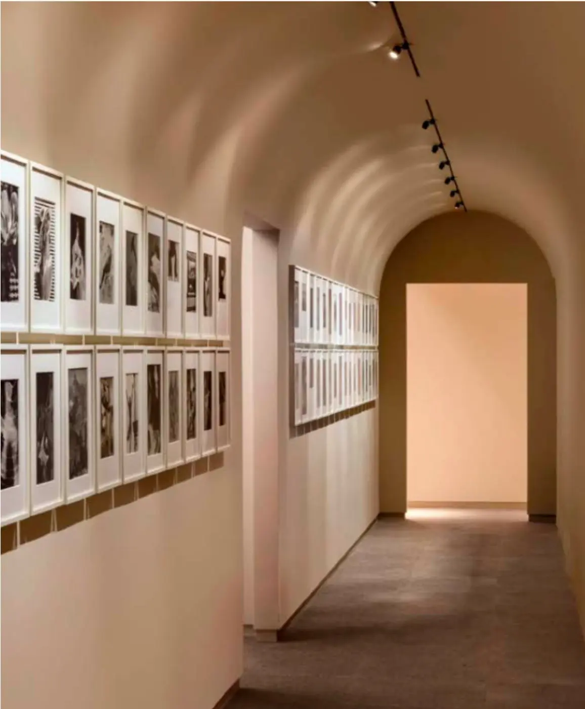 Gallery corridor at Crown Shy with framed prints and arched passage