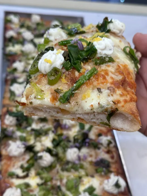 Gourmet focaccia slices at Crustinos Pizza, featuring fresh mozzarella and herbs.