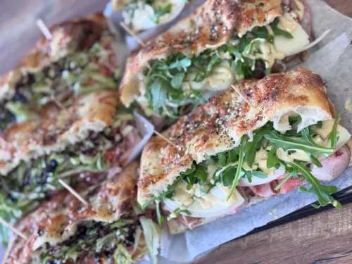 Fresh focaccia bread at Crustinos Pizza, topped with herbs and baked to perfection.