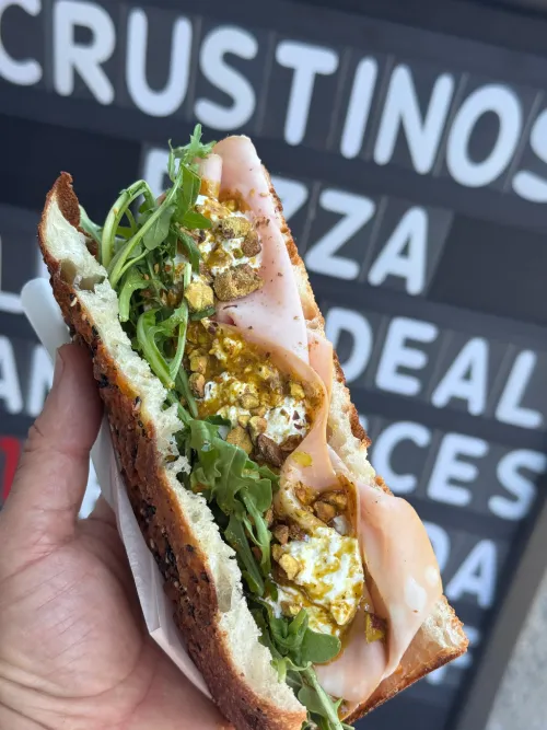 Freshly made pizza slice at Crustinos Pizza, served hot with premium toppings.