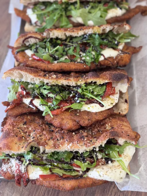 Double-stacked Italian sandwiches from Crustinos Pizza, made with fresh focaccia.