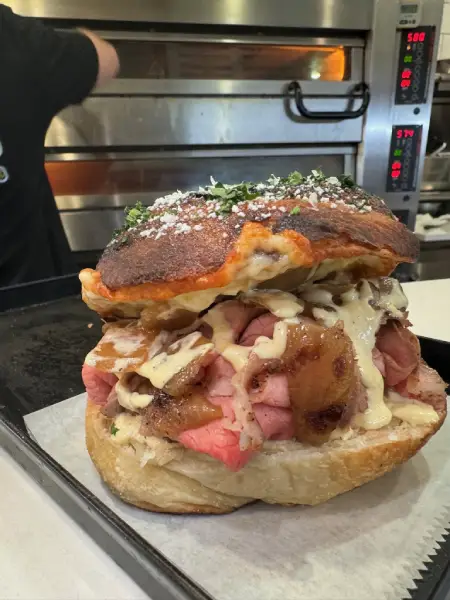 Crustinos Pizza Italian sandwich on focaccia, layered with meats and melted cheese.