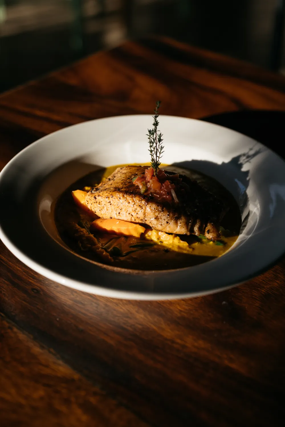 Grilled Caribbean snapper with local vegetables, served at Rockhouse Restaurant in Negril, Jamaica, showcasing fresh seafood cuisine at Rockhouse Hotel.
