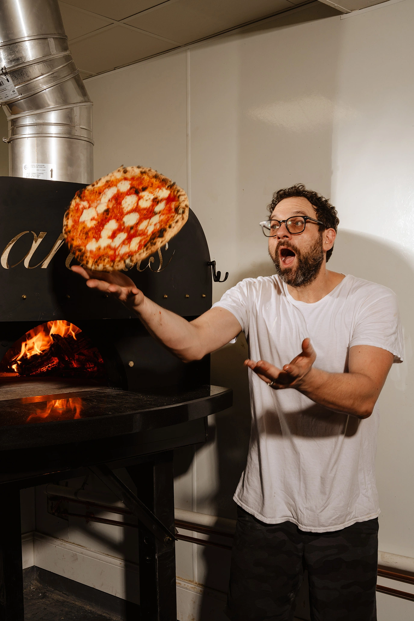 Chef Anthony Giordano Flips a pizza in the air with great skill and whismy