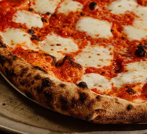 Close-up of Neapolitan margherita pizza with melted mozzarella and tomato sauce at Anna’s Vesuviano in Providence, Rhode Island