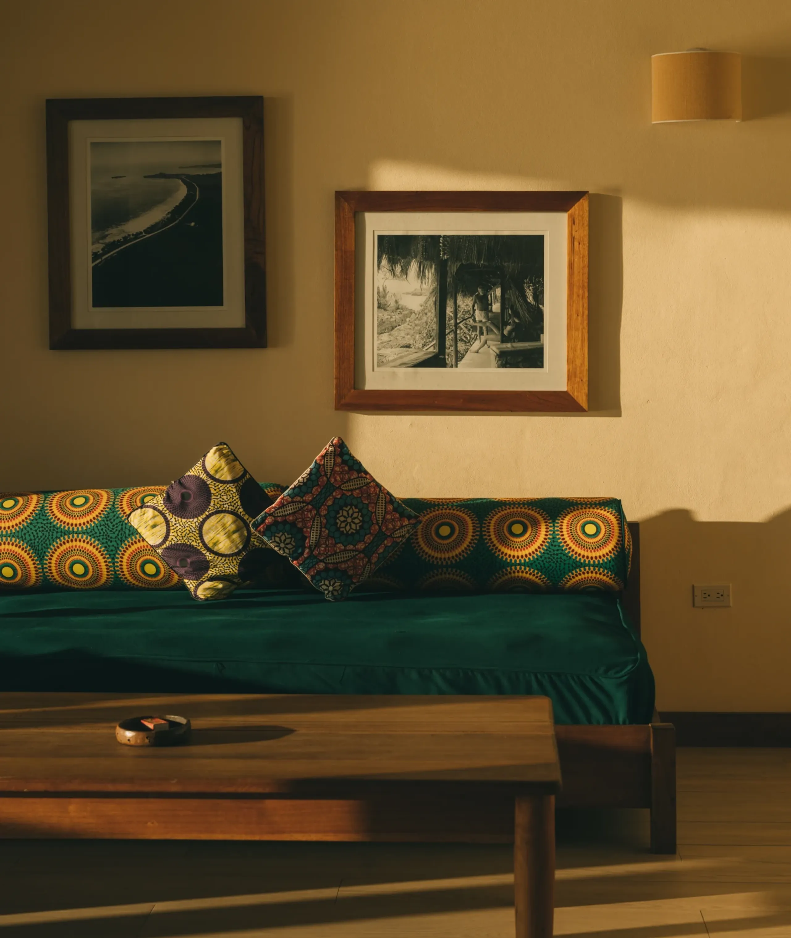 Luxury villa interior at Rockhouse Hotel featuring vintage Negril photographs, African-inspired textiles, and custom furniture, showcasing Caribbean-modern design in Jamaica