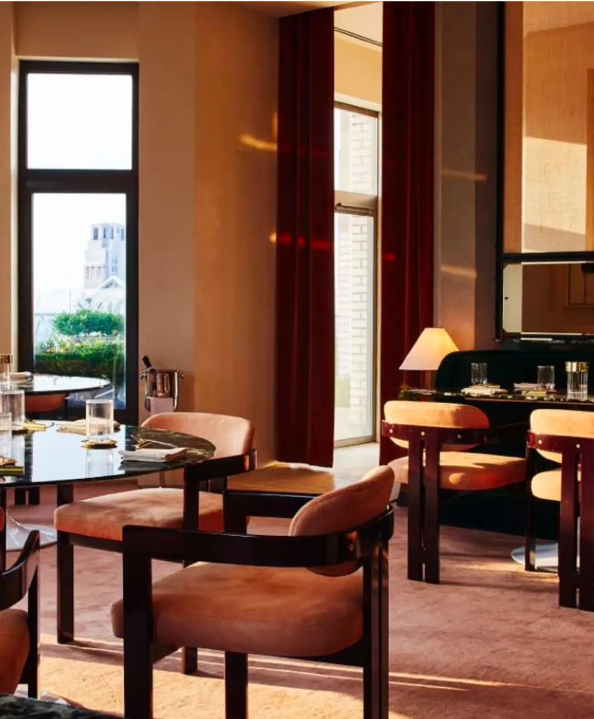Saga dining room with velvet chairs and terrace views at 70 Pine